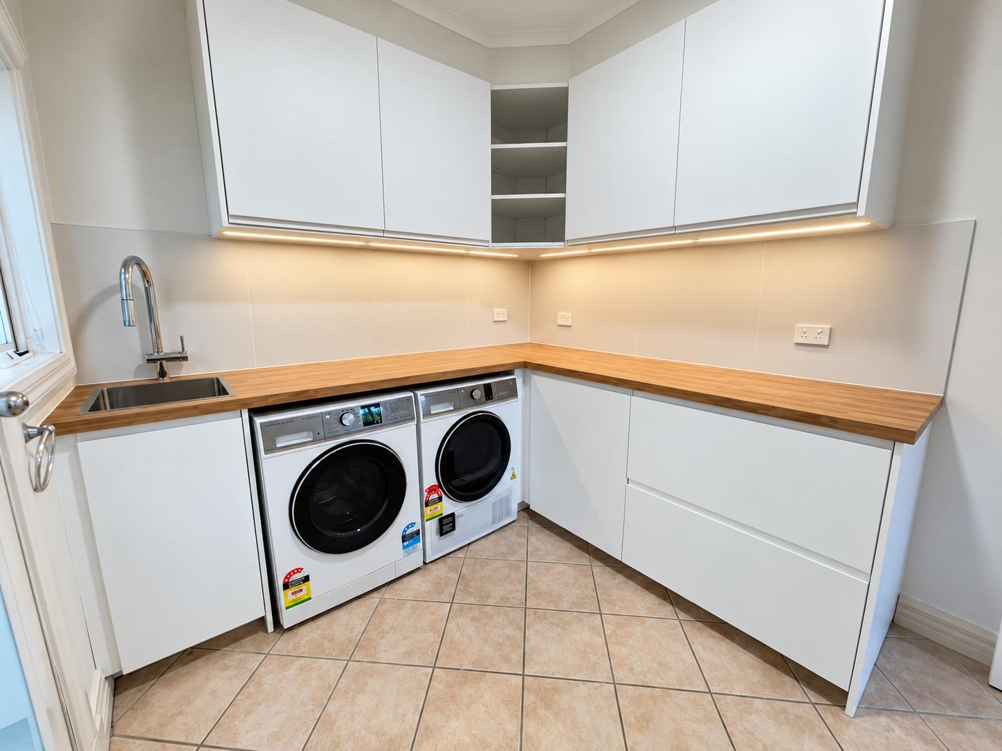 Camberwell laundry with timber worktop and white cabinetry