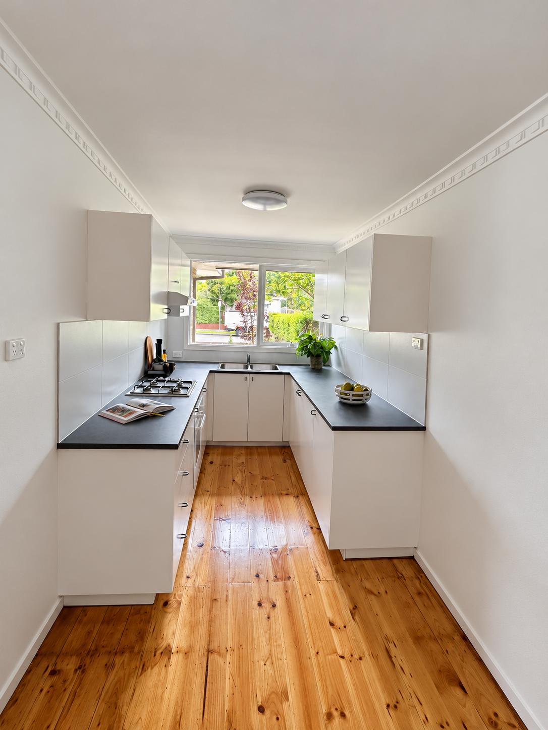 Renovated Carnegie kitchen using builder’s range finishes